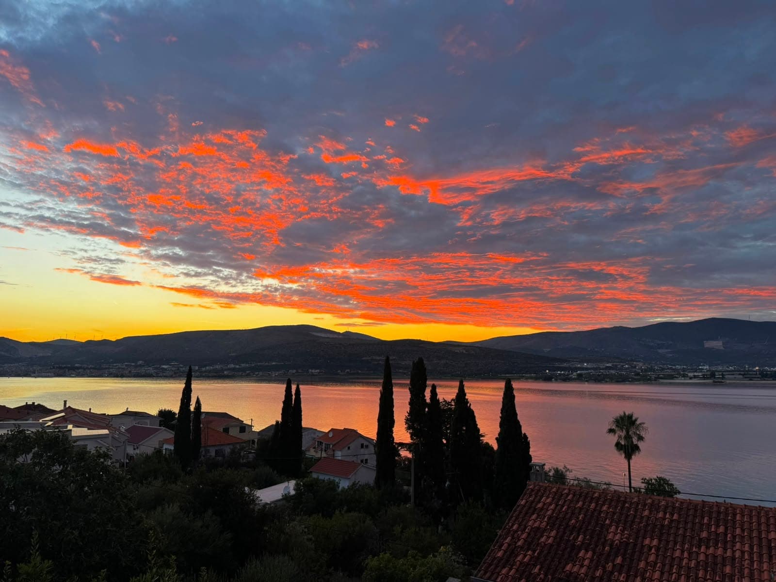 Sunset over the bay of Trogir, seen from the apartment's balcony in Mastrinka